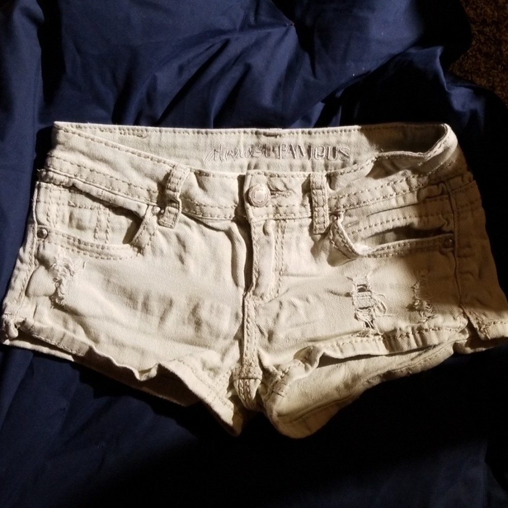 Distressed cream low rise jean shorts